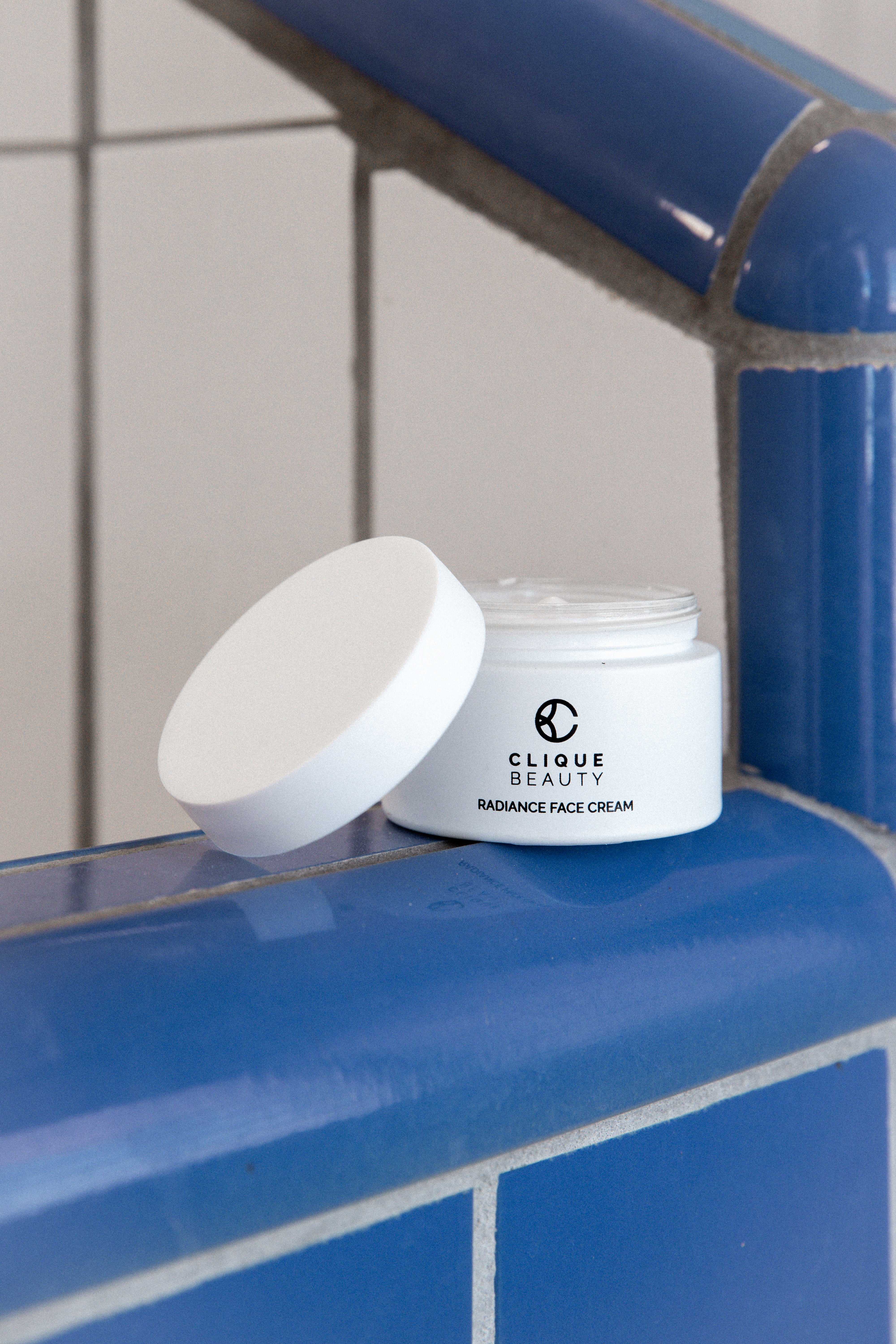 Radiance Face Cream jar styled with the wider Clique Beauty routine
