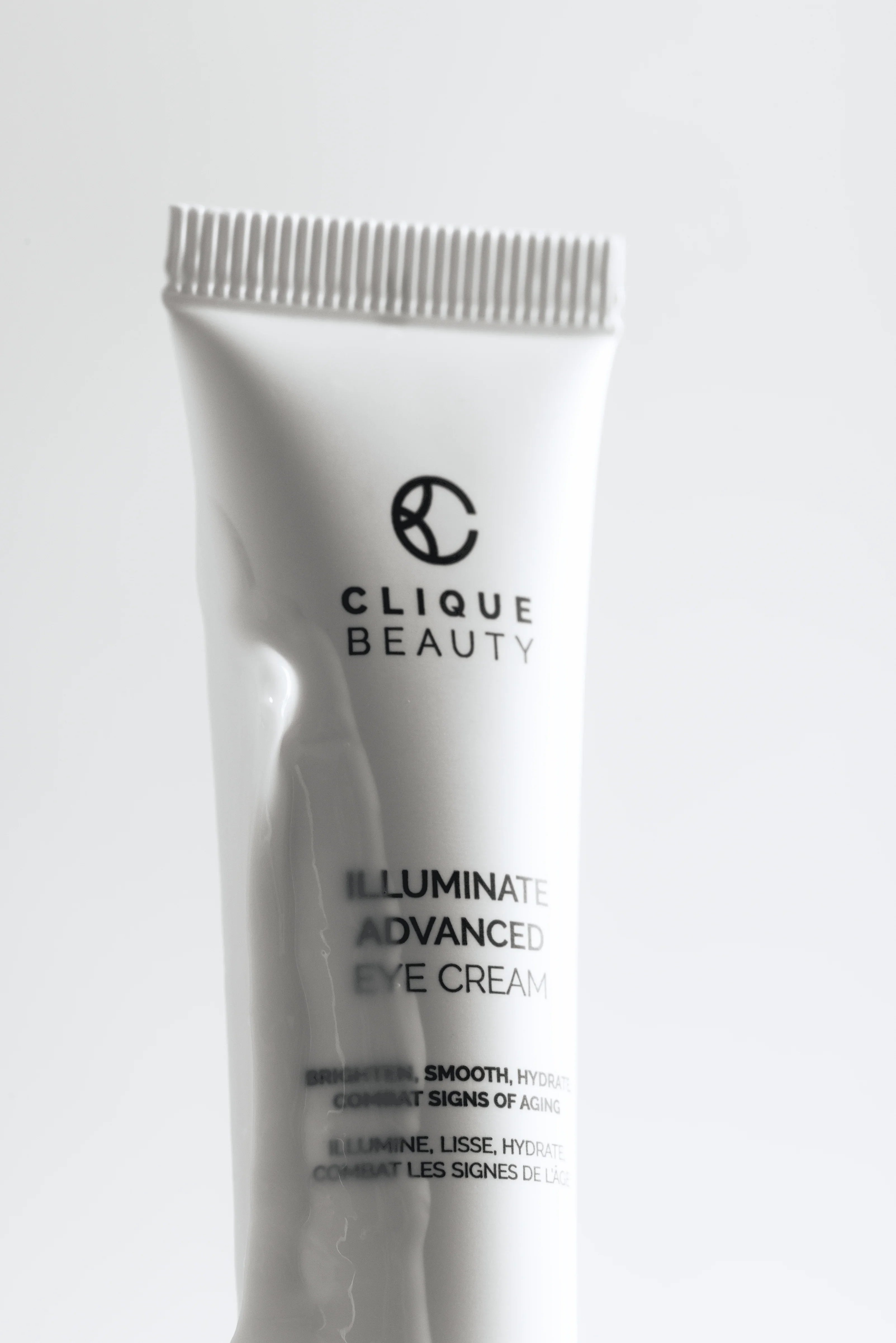 Clique Beauty skincare products arranged on a pale stone surface