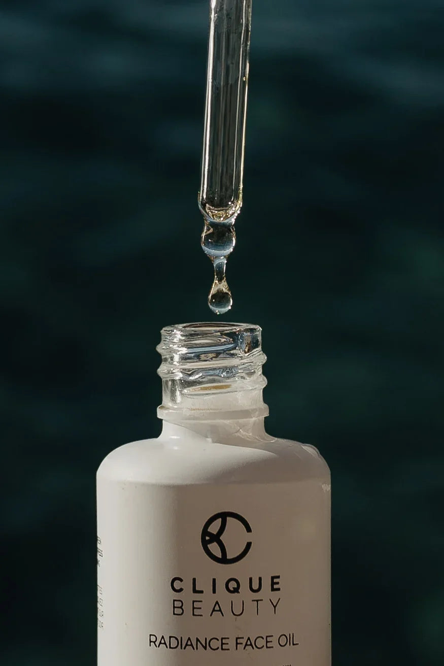 Drop of Radiance Face Oil suspended from the glass dropper