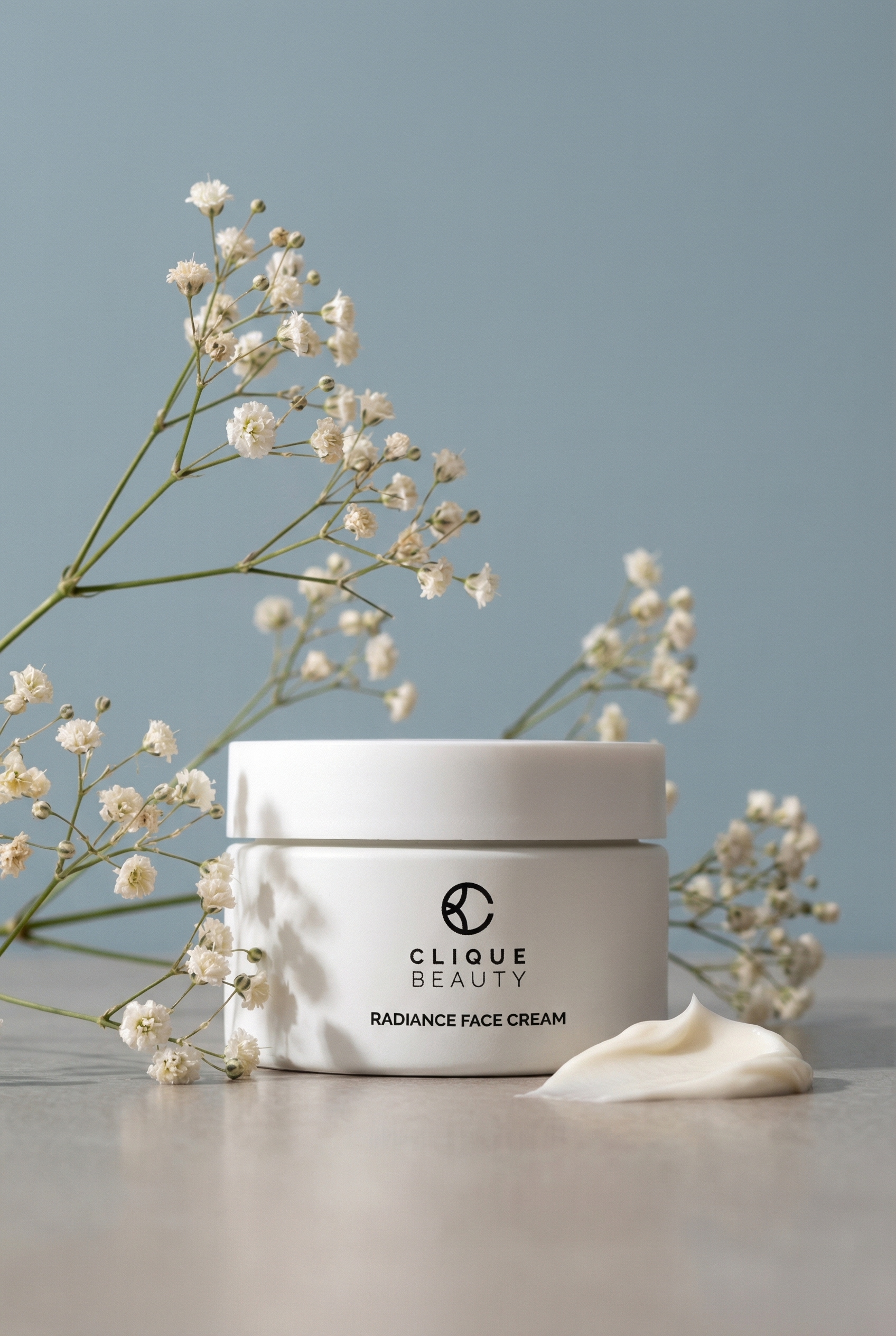 Clique Beauty radiance face cream jar with flowers on a gray background